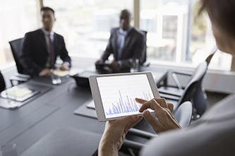 woman on iPad with chart in meeting