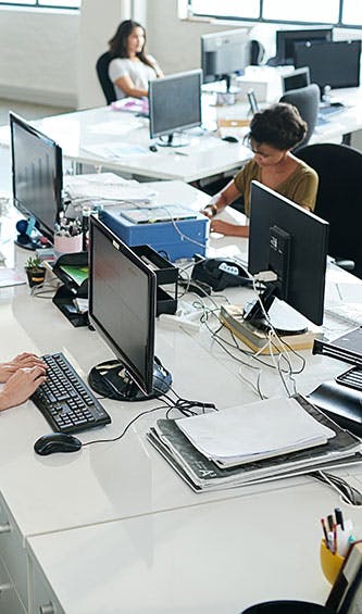 busy office with many devices in use