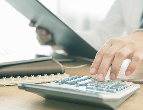 Close up professional making calculation with clipboard in hand