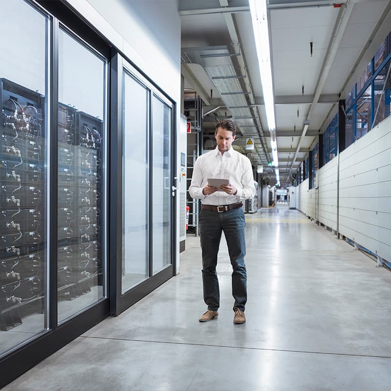 Businessman using tablet in server room
