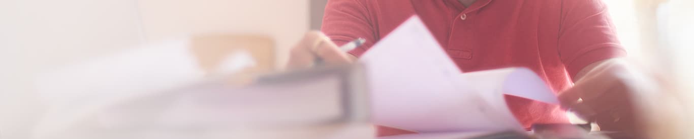 Close up of man working on paperwork finances