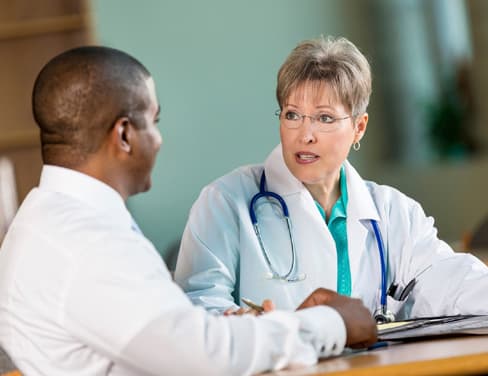 Doctor and clinic employee discussing.