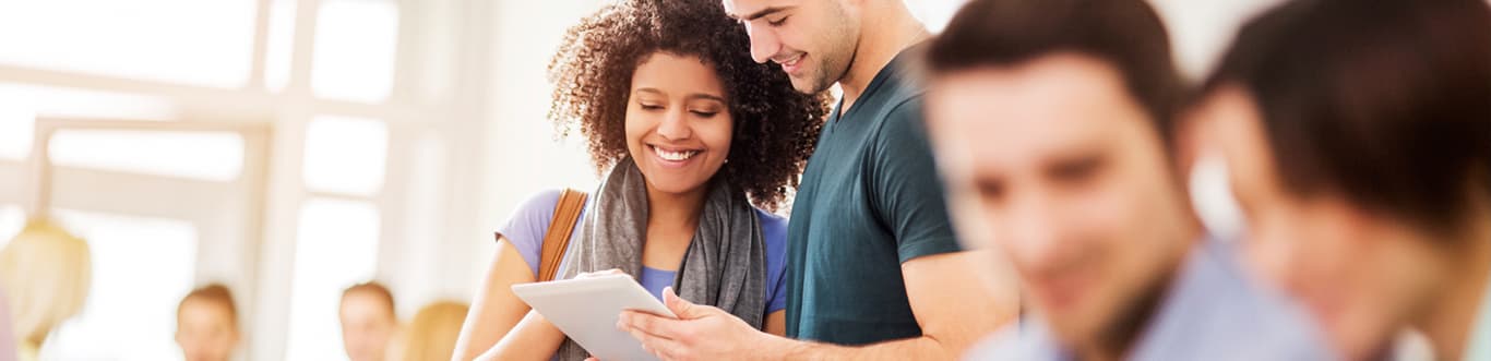 Two college students with touchpad