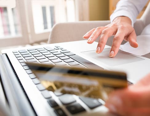 Closeup of hands using a laptop touchpad