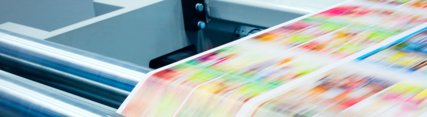 Printing press in action with colorful print pieces