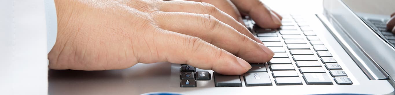 Doctor resting hands on keyboard