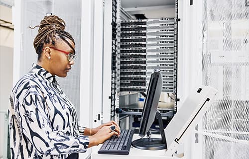 Shot of a young woman using a digital tablet while working in a server room