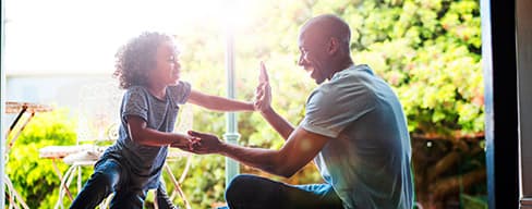 Photo of a father and son playing.