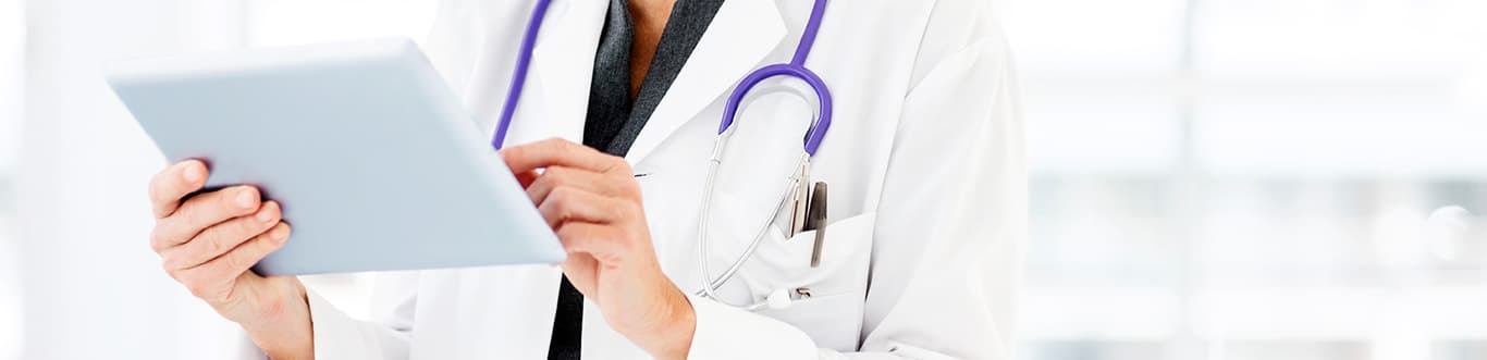 Female doctor using tablet device