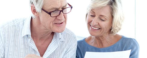 Senior couple looking at printed documents.