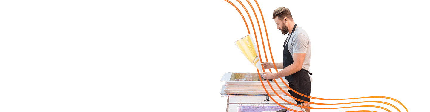 Man wearing black apron using a printer, depicting an offset to digital services.