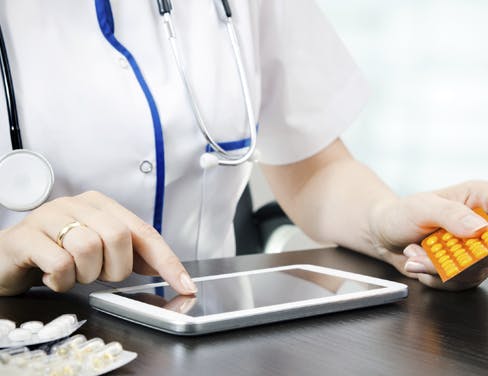 Close up of doctor using a tablet
