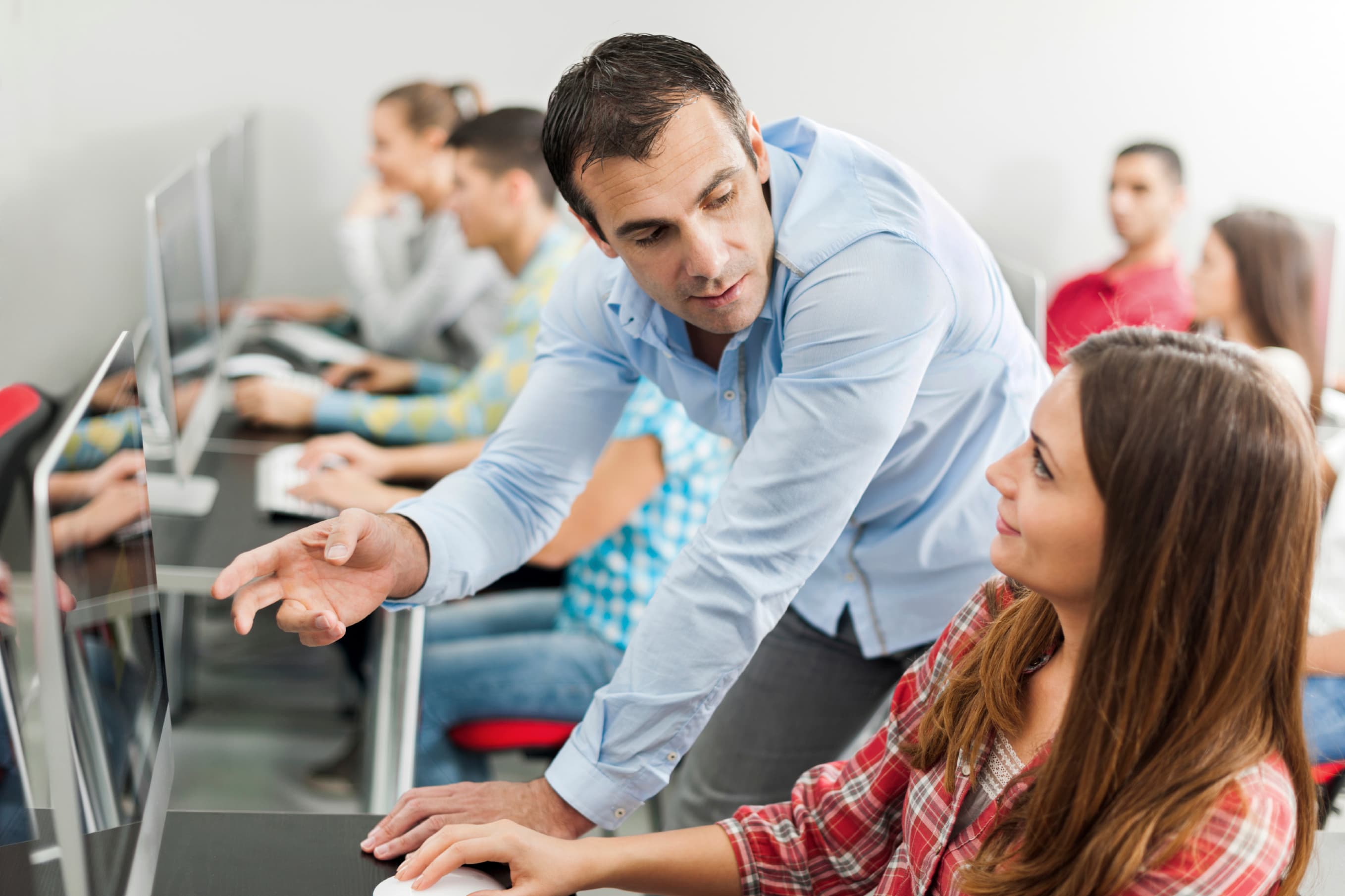 High school teacher and student discussing.
