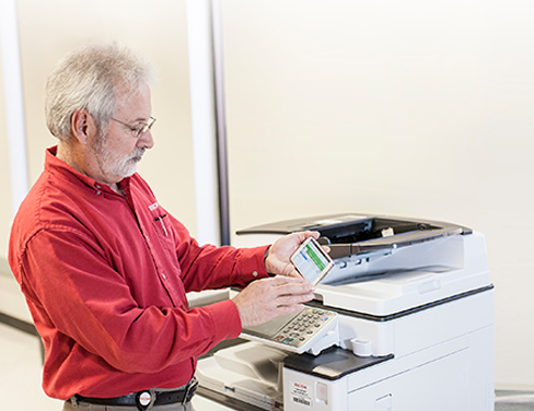 ricoh employee at printer interacting