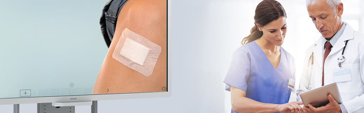 Doctors reviewing tablet with Alnus Interactive Whiteboard