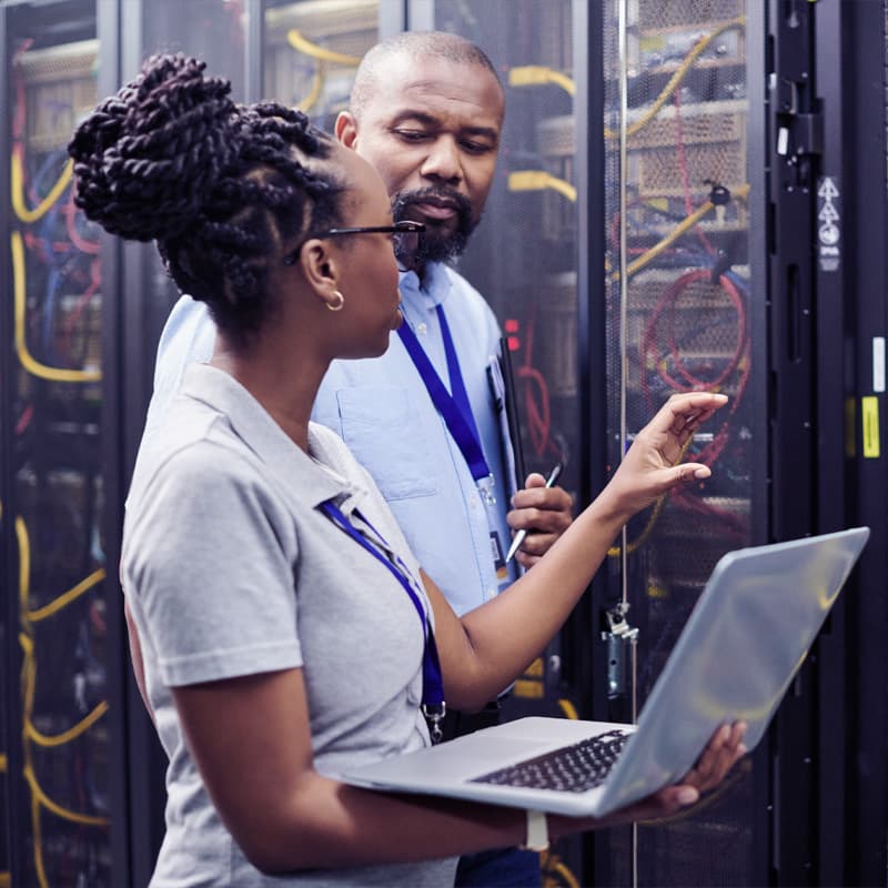 Business people setting up cybersecurity using a tablet computer in server room