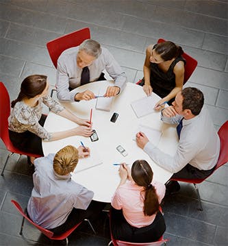 overhead photo of a business meeting around a table